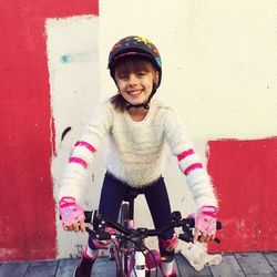 Portrait of smiling girl playing with bicycle