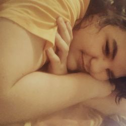 Close-up of woman sleeping on bed