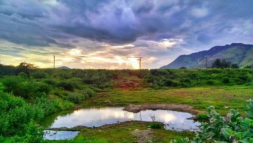 Scenic view of lake against cloudy sky