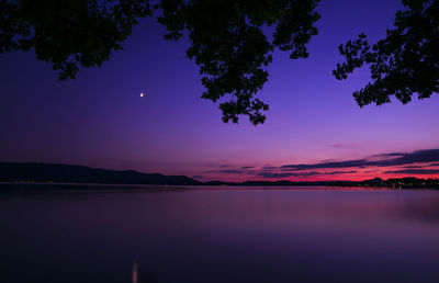 Scenic view of lake against sky at sunset