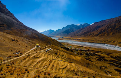 Scenic view of mountains against blue sky