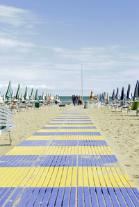 Panoramic view of people on beach against sky