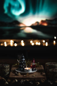 Close-up of illuminated candles on table