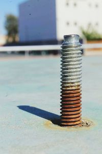 Close-up of metal screw on road