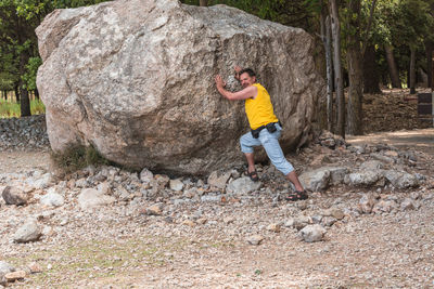 Man pushing boulder at serra de tramuntana