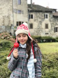 Portrait of smiling girl standing in snow