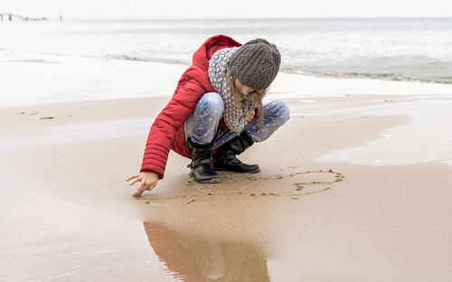 Boy playing on sand at beach