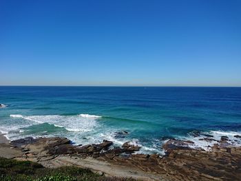 Scenic view of sea against clear blue sky