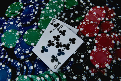 High angle view of cards and gambling chips on table