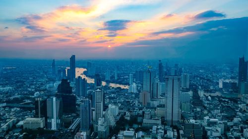 Aerial view of city buildings during sunset