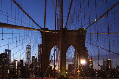 Bridge against illuminated buildings