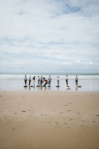 People on beach against sky