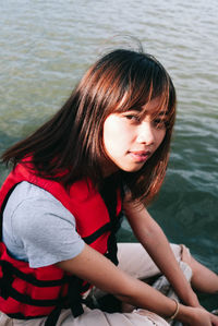 Portrait of woman sitting in lake