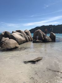 Rocks on beach against sky