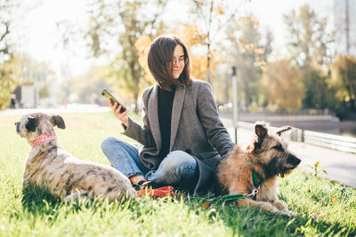 Rear view of woman with dog on field