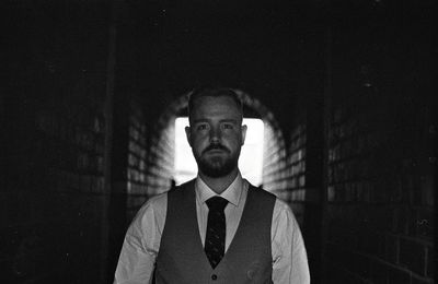 Portrait of businessman standing in tunnel