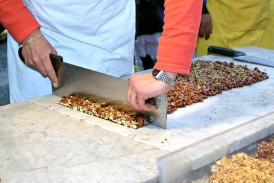 Stall with artisan preparing the traditional sicilian torrone