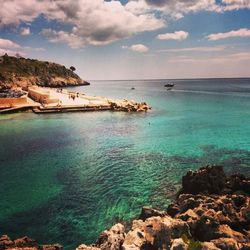 Scenic view of sea against cloudy sky