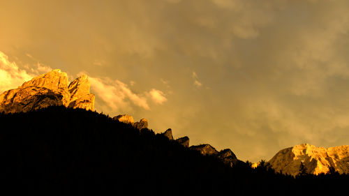 Low angle view of silhouette mountain against sky during sunset