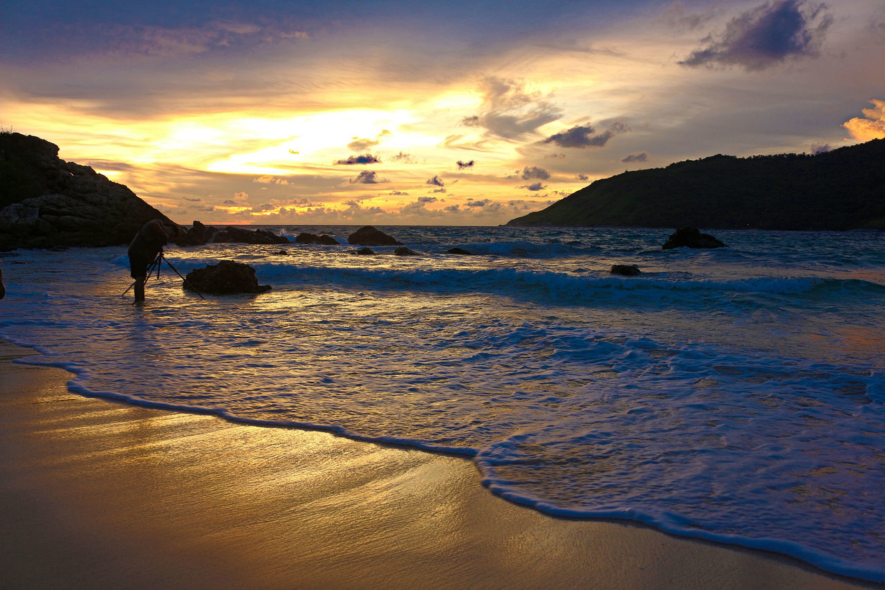 sunset, water, sea, beach, tranquil scene, scenics, sky, beauty in nature, tranquility, shore, orange color, cloud - sky, idyllic, nature, sand, reflection, horizon over water, mountain, cloud, coastline