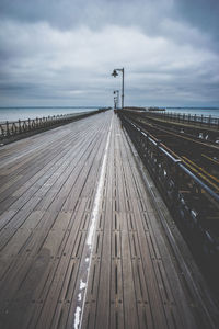 High angle view of empty road by sea against sky