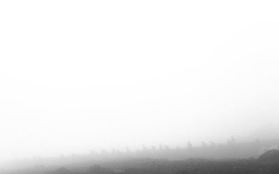 Scenic view of mountains in foggy weather