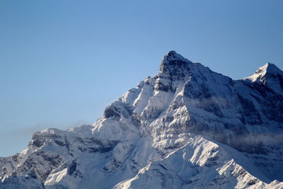Scenic view of snowcapped mountains against clear blue sky