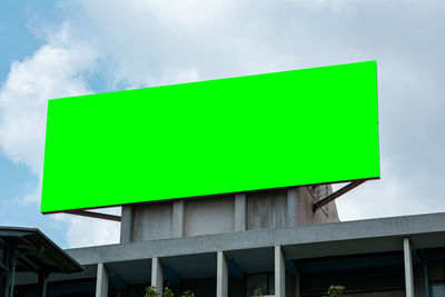 Low angle view of road sign against sky