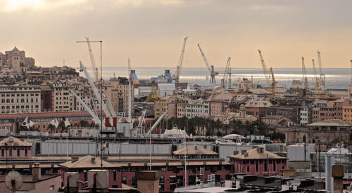 Sailboats in city at harbor against sky