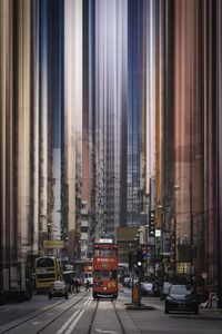 Cars on street by buildings in city