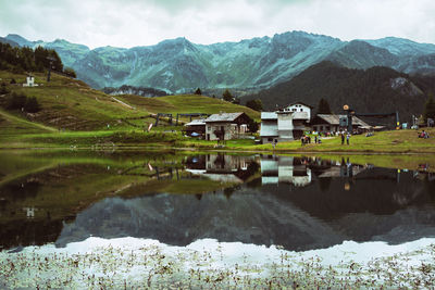 Scenic view of lake and mountains against sky