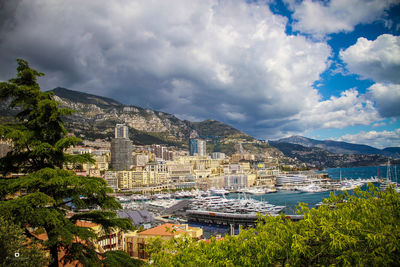 Scenic view of city by mountains against sky