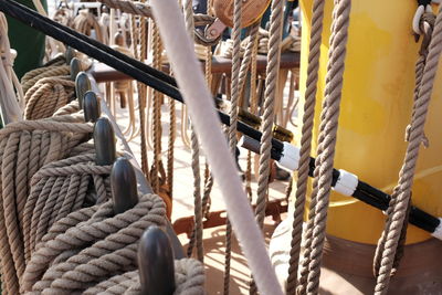 High angle view of ropes tied up to metal railing