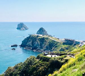 High angle view of mountain by sea against clear sky