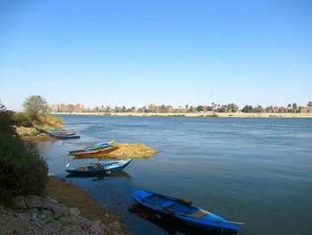 Scenic view of river against clear blue sky