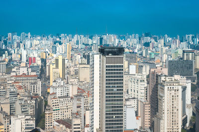 Aerial view of modern buildings in city against sky