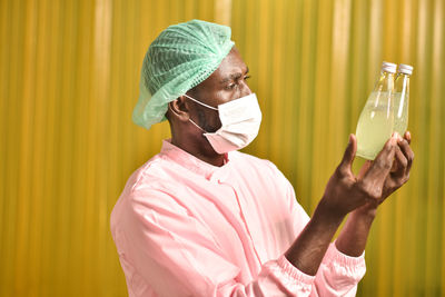 Side view of man working with umbrella