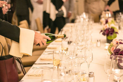 Cropped image of waiter pouring alcohol during event