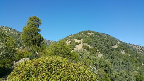 Scenic view of mountains against clear blue sky