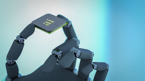 High angle view of computer keyboard on table against blue wall