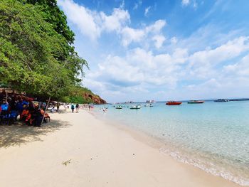 People on beach against sky