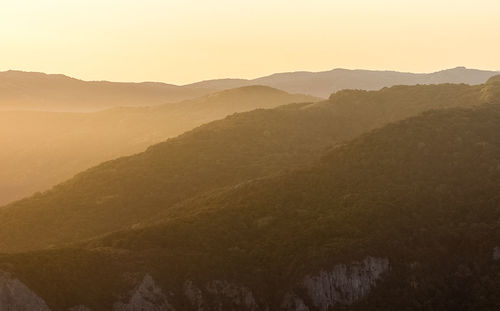 Scenic view of mountains against sky during sunset