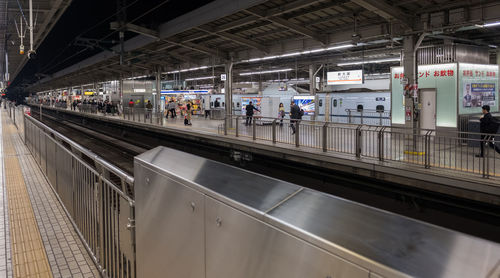 People waiting at railroad station platform