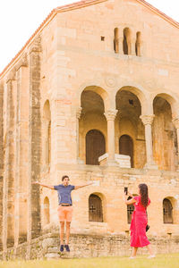 Low angle view of people in front of historic building