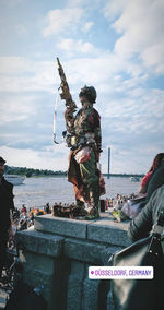 People in front of sea against sky