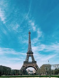 Low angle view of eiffel tower against cloudy sky