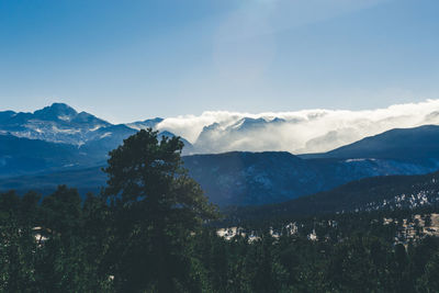 Scenic view of mountains against blue sky