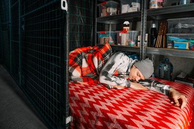 Man sleeping in underground emergency shelter during shelling