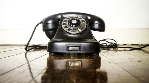 Close-up of old telephone on table