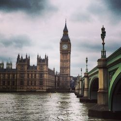 Big ben and city against cloudy sky